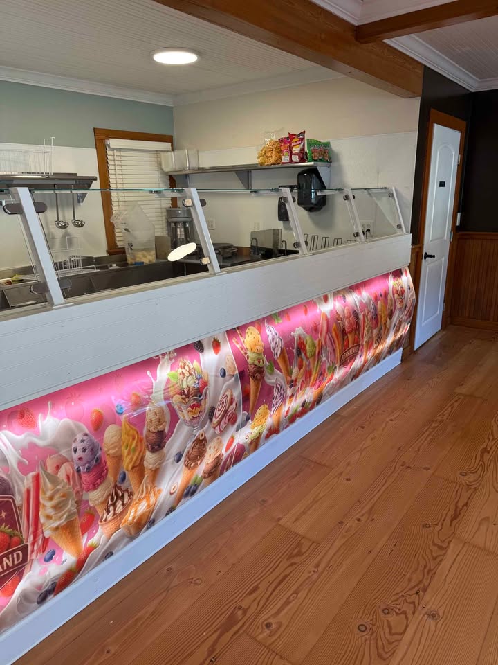 Inside Paletería Los Freseros, the serving counter and ice cream case