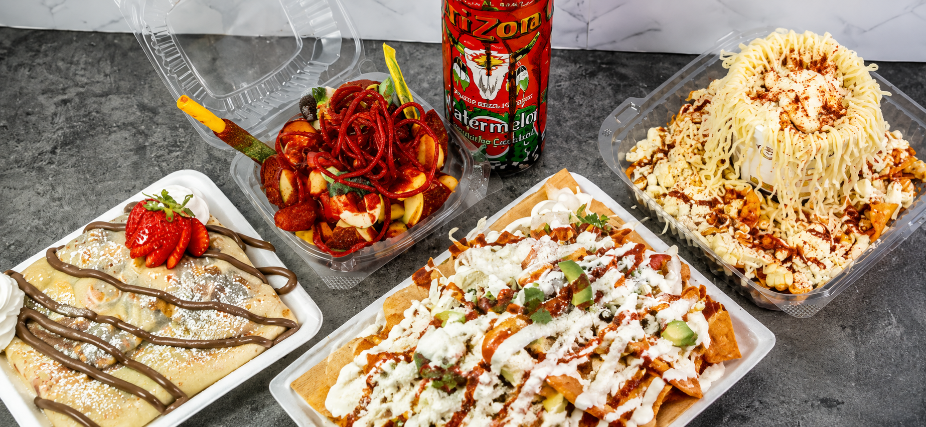 A spread of Los Freseros antojitos: Nutella crepe, Manzana Loca, Arizona Loca, and Tostielote Mixto